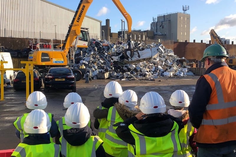 Children being shown round scrap metal site