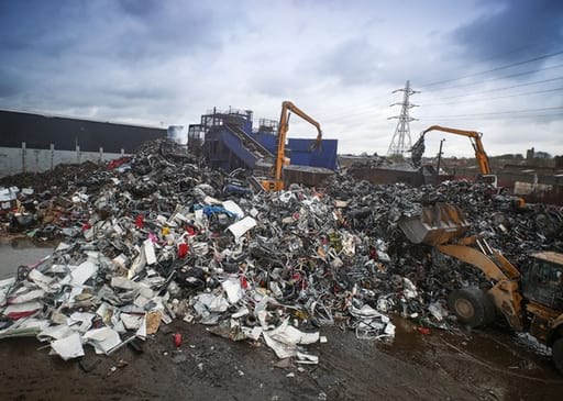 Cranes working with scrap metal pile
